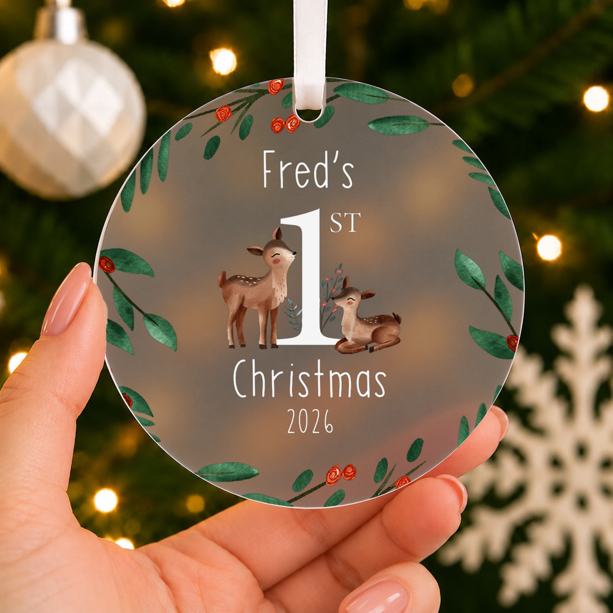 Personalised Baby's First Christmas Bauble – Deer & Winter Wreath – shown held in the hand