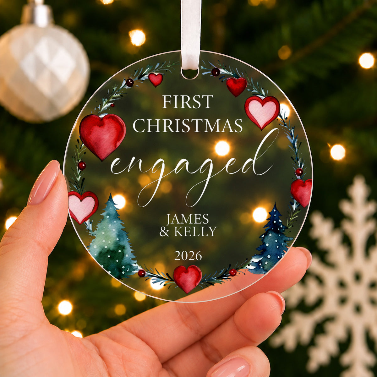 Personalised First Christmas Engaged Bauble – Heart Wreath Design – shown held in the hand