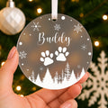 Personalised Pet Name Christmas Bauble – Paw Prints & Snowflakes – shown held in the hand