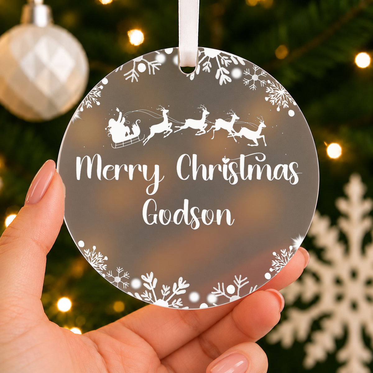 Personalised Godson or Goddaughter Christmas Bauble – Santa Sleigh Design – shown held in the hand