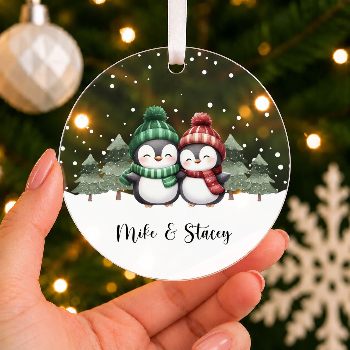 Personalised Penguin Couple Christmas Bauble – Both Names – shown held in the hand