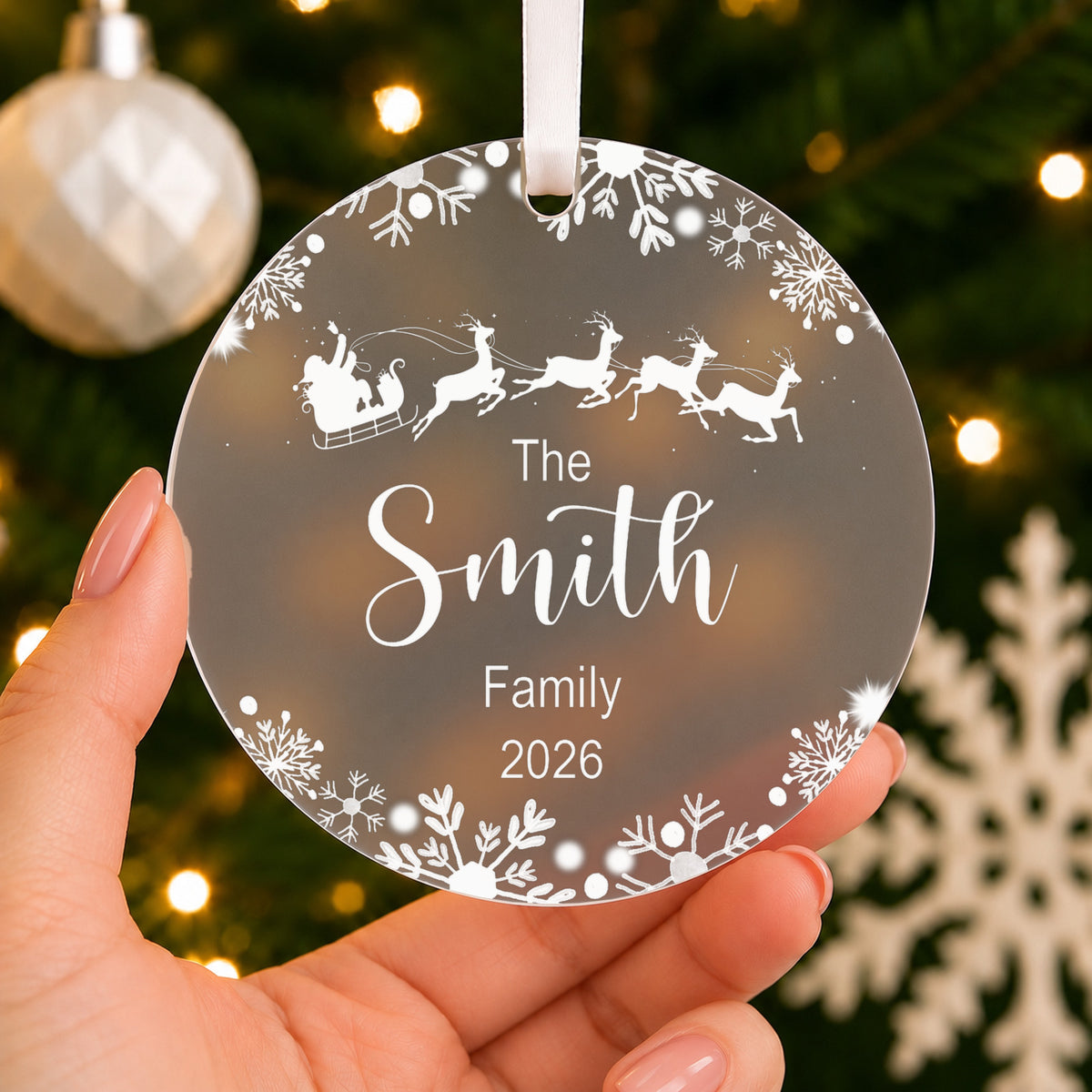 Personalised Family Name Christmas Bauble – Santa Sleigh Design – shown held in the hand