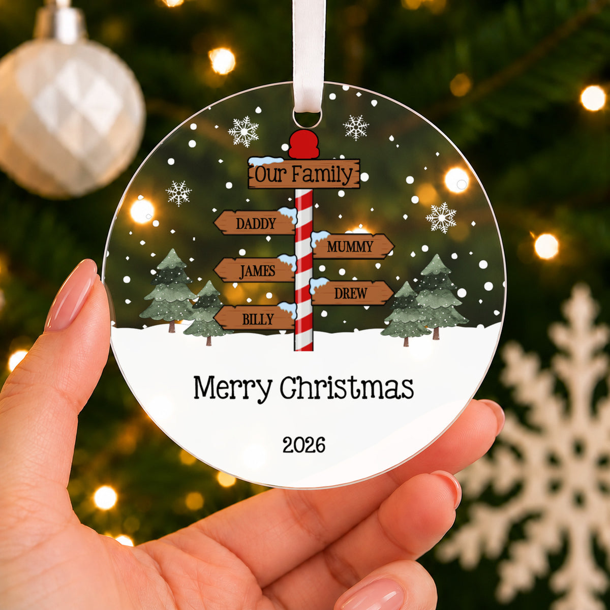 Personalised North Pole Signpost Christmas Bauble – Family Names – shown held in the hand
