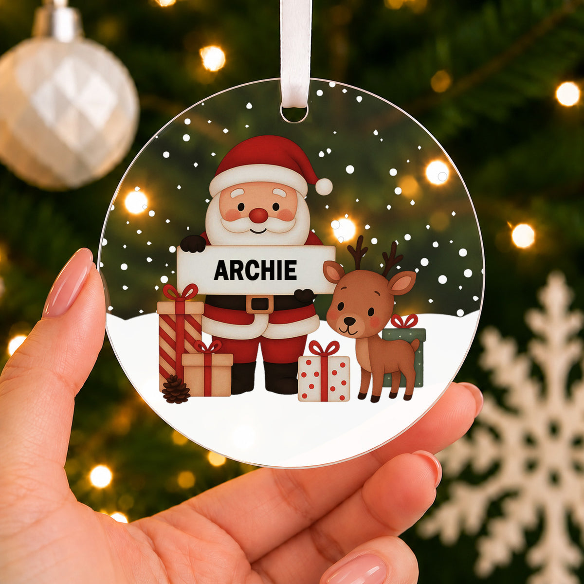 Personalised Santa & Reindeer Christmas Bauble – Child's Name – shown held in the hand