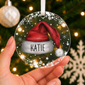 Personalised Santa Hat Christmas Bauble – Child's Name – shown held in the hand