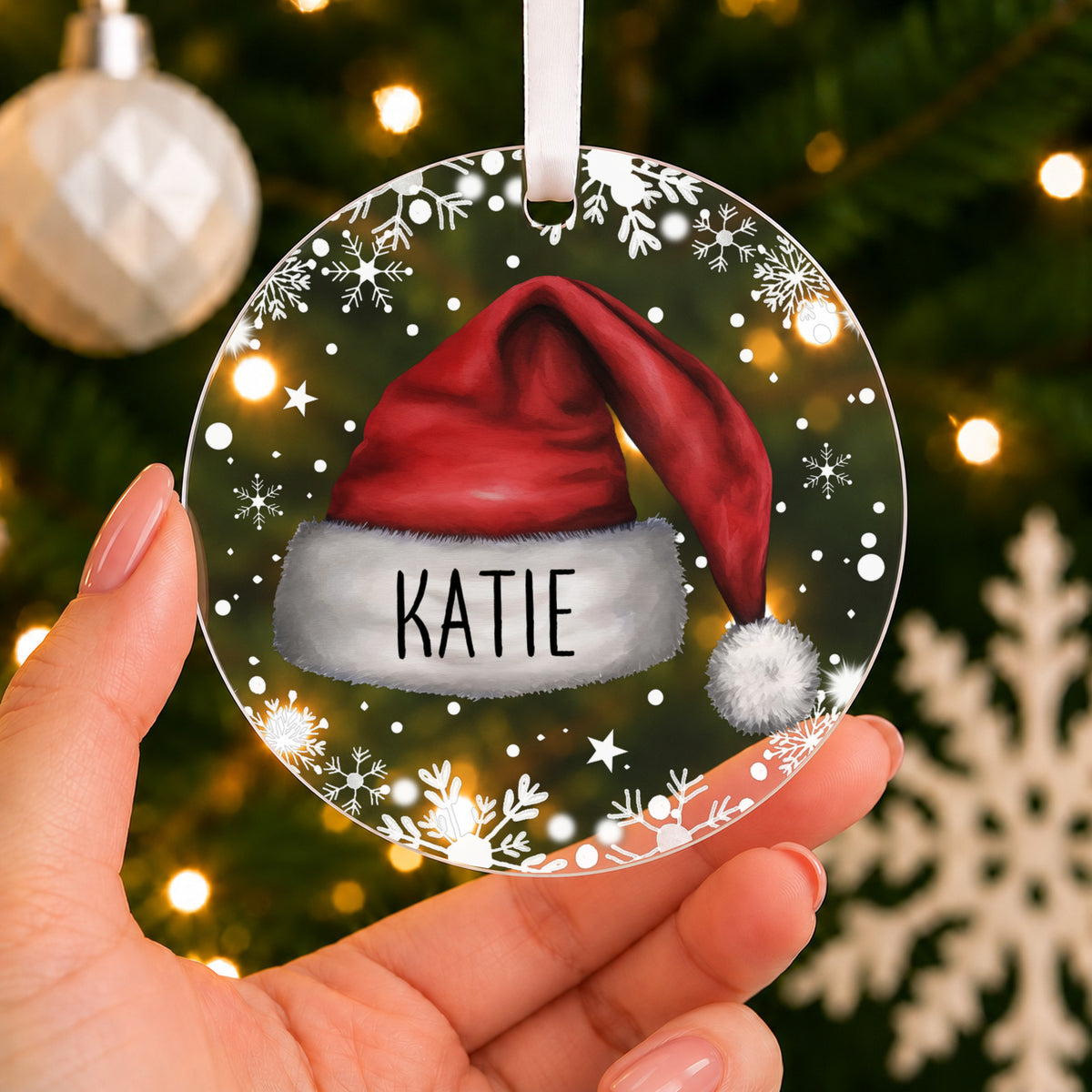 Personalised Santa Hat Christmas Bauble – Child's Name – shown held in the hand