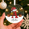 Personalised Initial & Name Christmas Bauble – Red Letter with Santa Hat – shown held in the hand
