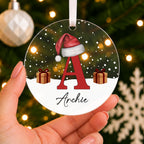 Personalised Initial & Name Christmas Bauble – Red Letter with Santa Hat – shown held in the hand
