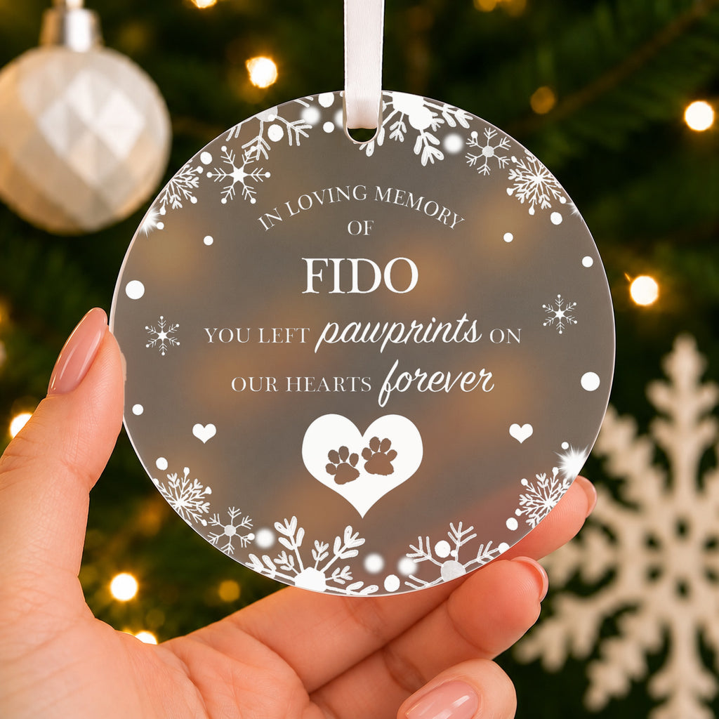 Personalised Pet Memorial Christmas Bauble – Pawprints on Our Hearts – shown held in the hand