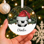 Personalised Football Christmas Bauble – Santa Hat Design with Name – shown held in the hand