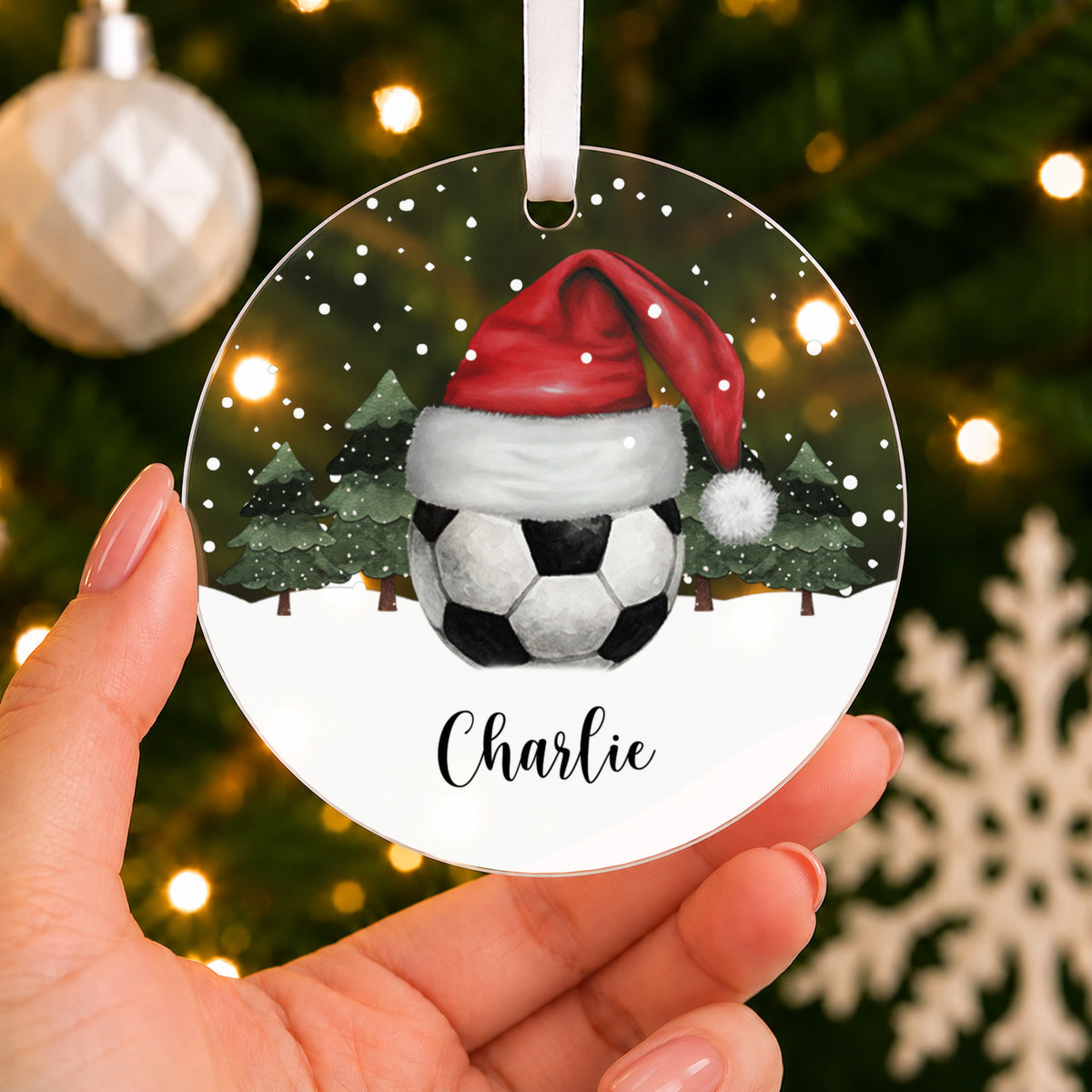 Personalised Football Christmas Bauble – Santa Hat Design with Name – shown held in the hand