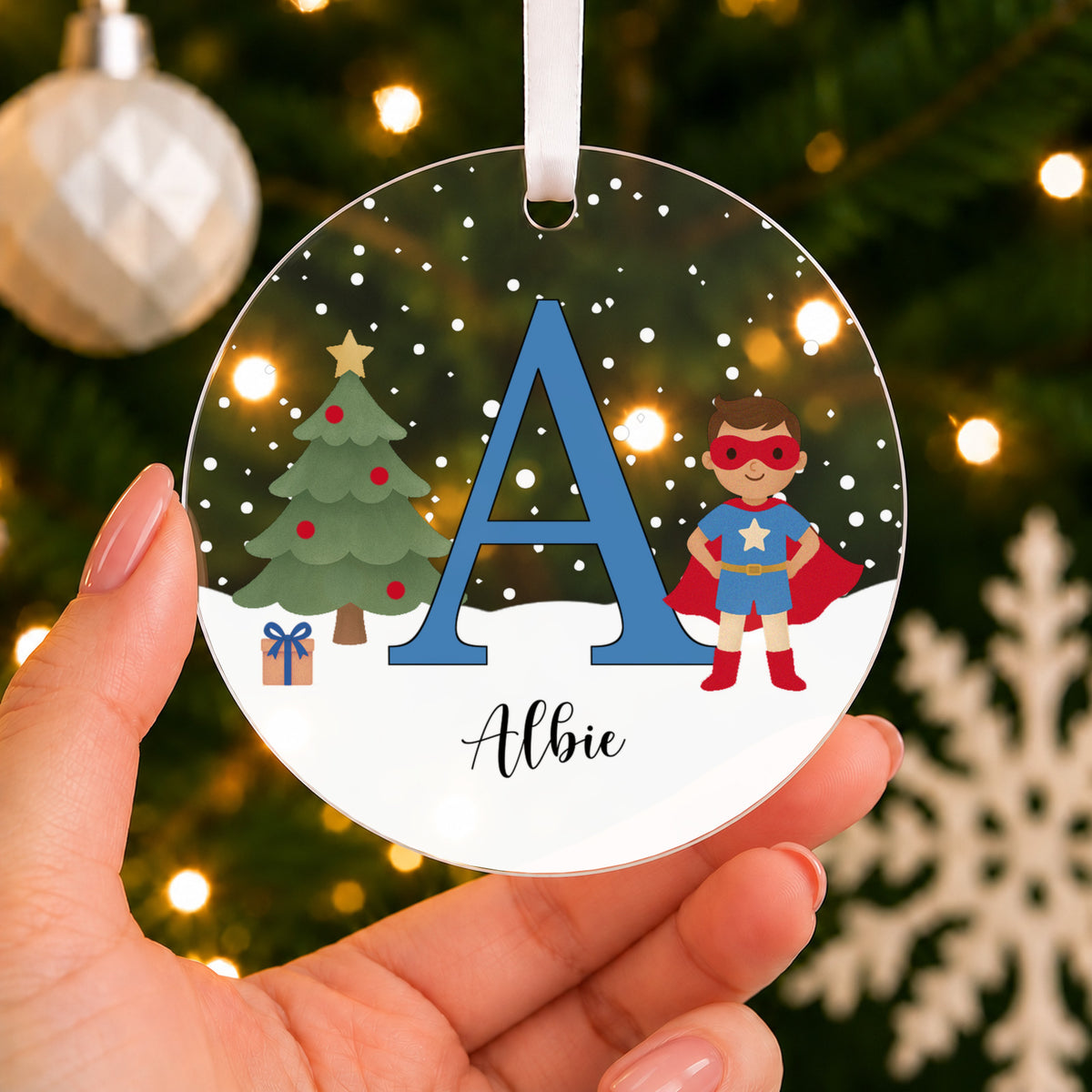 Personalised Superhero Christmas Bauble – Boy's Initial & Name – shown held in the hand