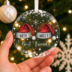 Personalised Best Friends Christmas Bauble – Santa Hats with Both Names – shown held in the hand