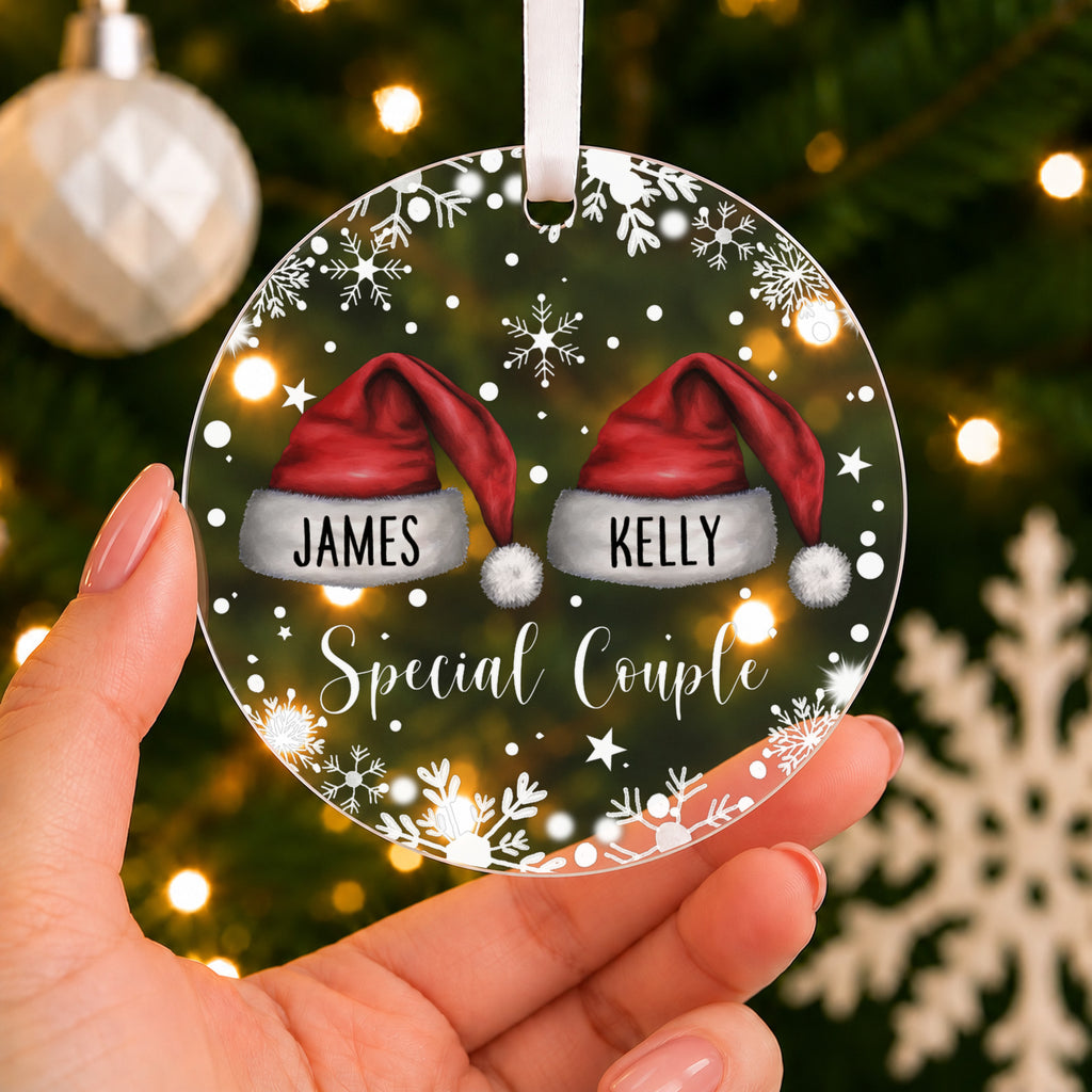 Personalised Special Couple Christmas Bauble – Santa Hats with Both Names – shown held in the hand