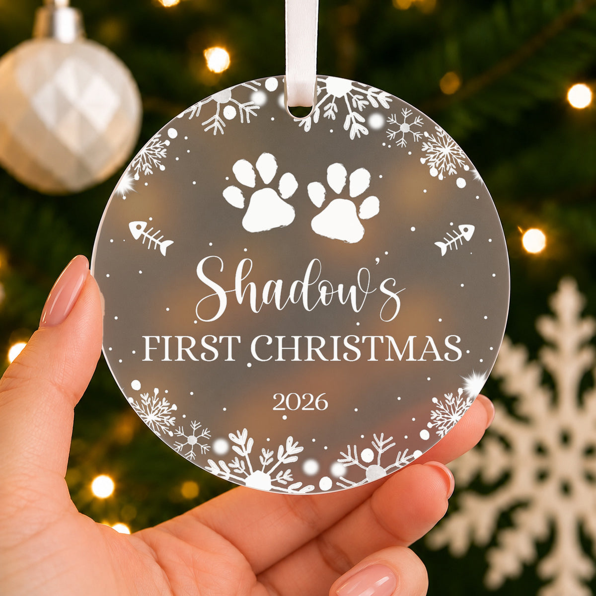 Personalised Cat's First Christmas Bauble – Paw Print Design – shown held in the hand